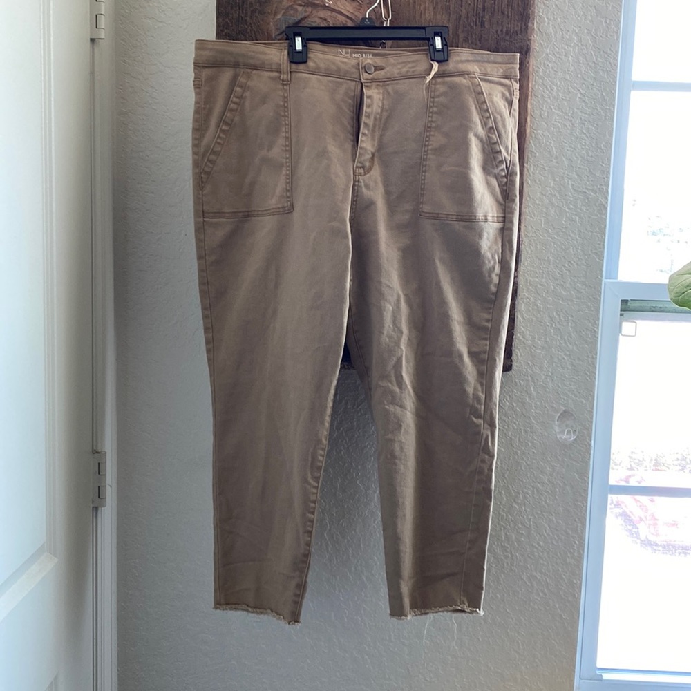 Tan crop pants with fringed legs. One belt loop is broken.